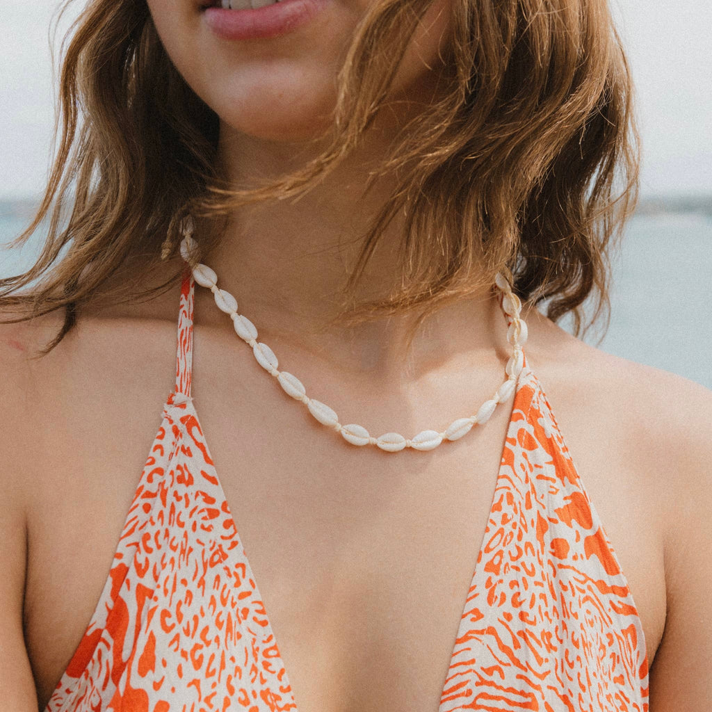 a close up of a person wearing a bikini top